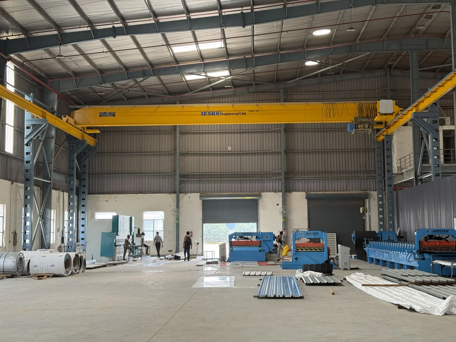 Inside the Avabro Steels plant — twin overhead gantry cranes spanning the roll-forming bay